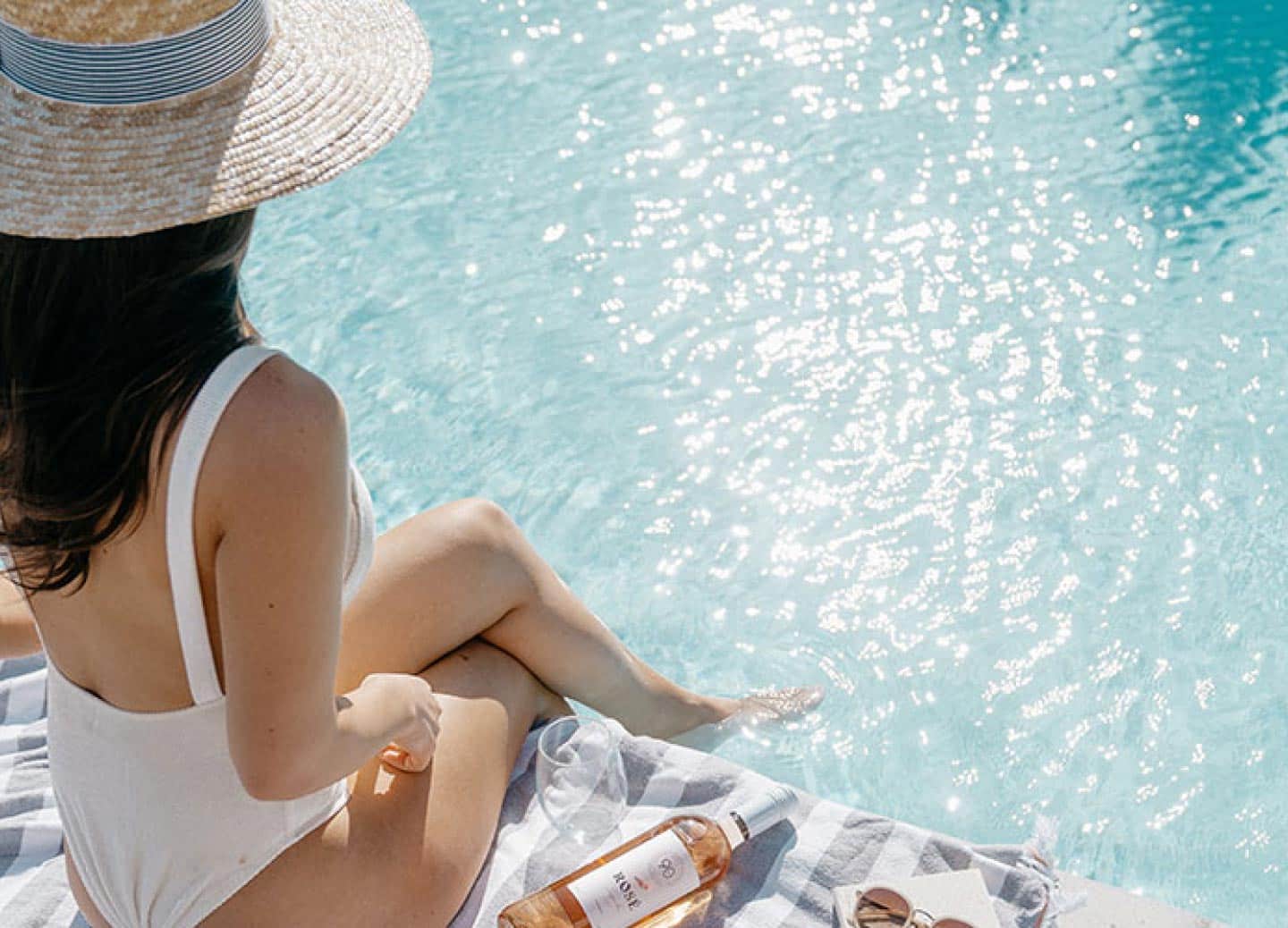 girl by pool with wine